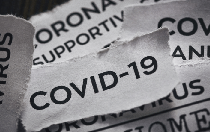 Ripped pieces of paper that have different ways of saying coronavirus or COVID-19