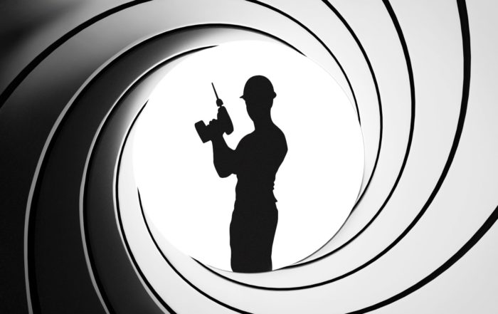 James Bond themed image with a silhouette of a construction worker posing with a drill