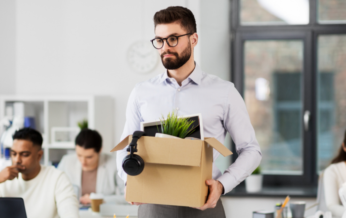 Redundant person leaving with a box of their belongings