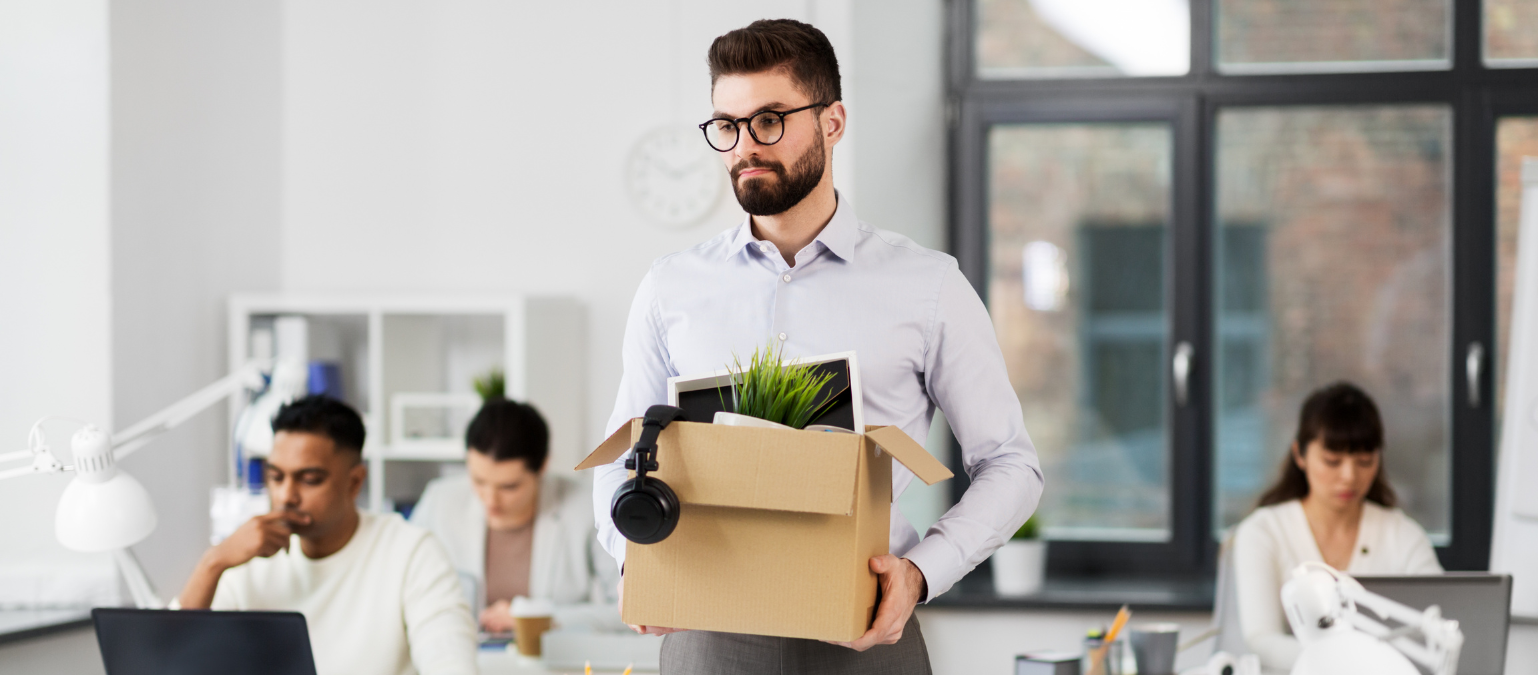 Redundant person leaving with a box of their belongings